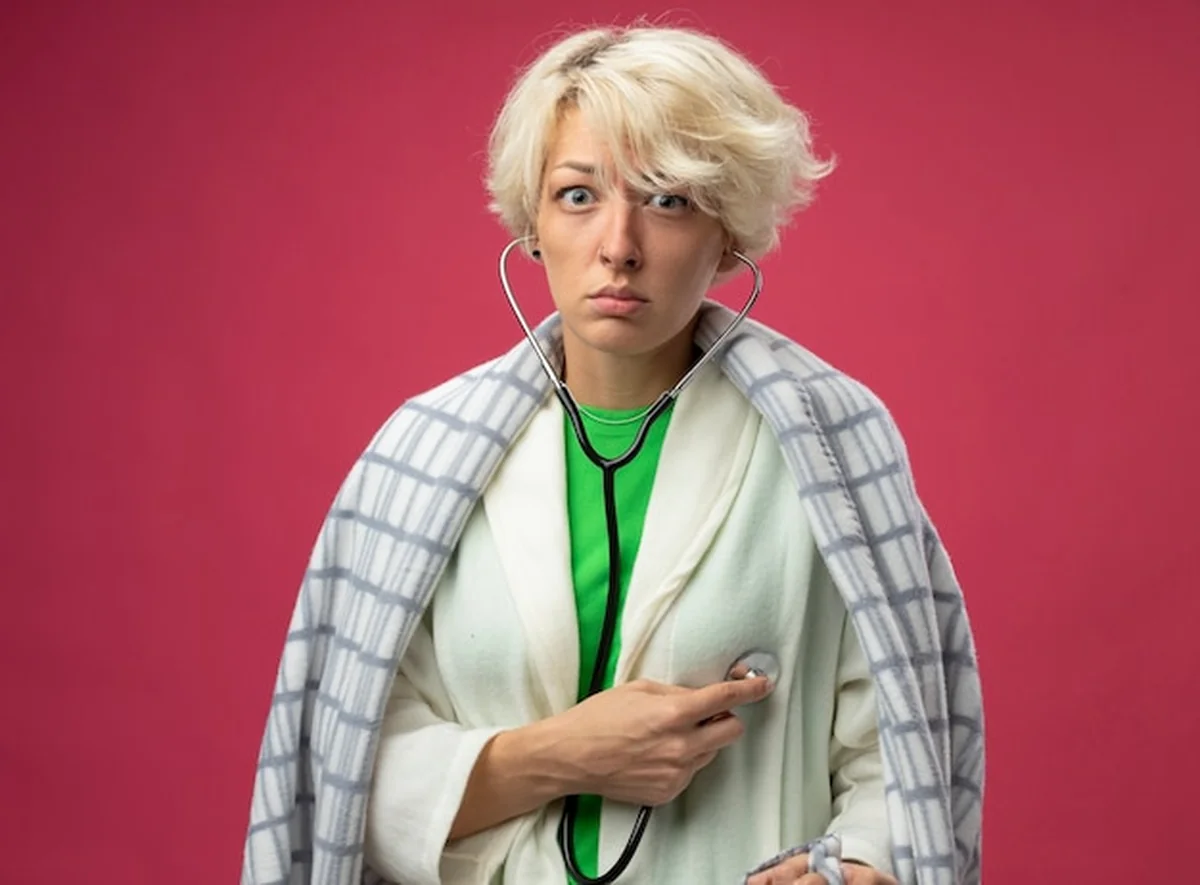 Kobieta ze stetoskopem słuchająca serca na różowym tle