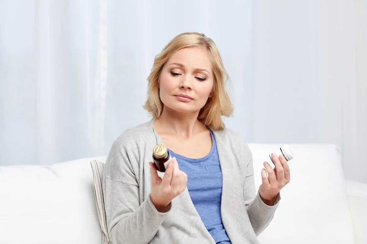 Kobieta patrząca na słoiki z lekarstwami